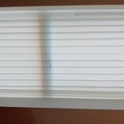 White vertical blinds in a window.