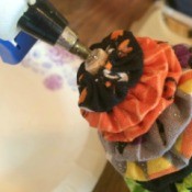 Glue being applied to the end of a Halloween Yo Yo Tree.