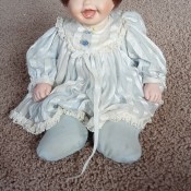 A baby doll with a porcelain head.