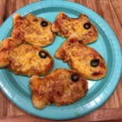 A plate of goldfish shaped cheese pizzas.